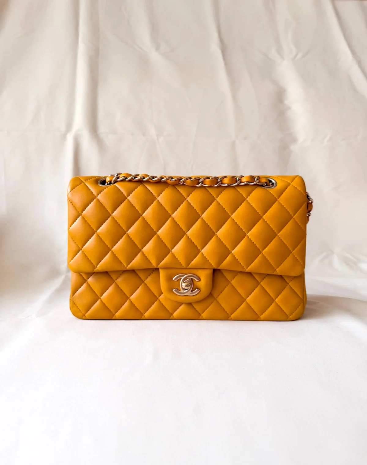 Chanel Classic Flap Medium mustard yellow lambskin bag with champagne hardware front view