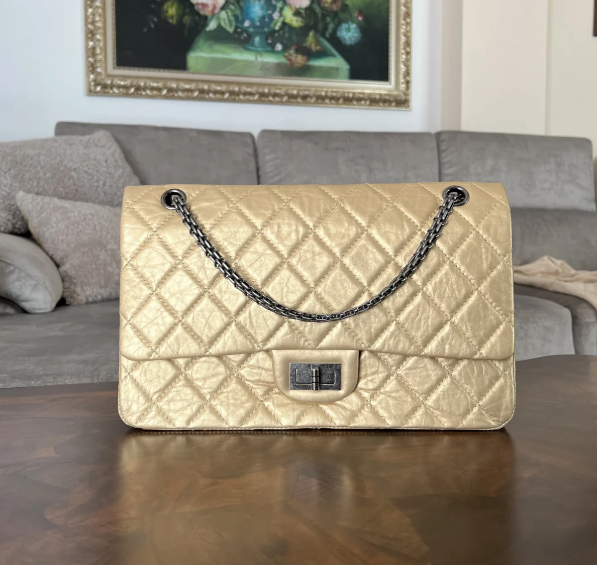 Chanel 2.55 Reissue 227 Large in metallic champagne aged calfskin with antique silver-tone hardware, front view in natural light.