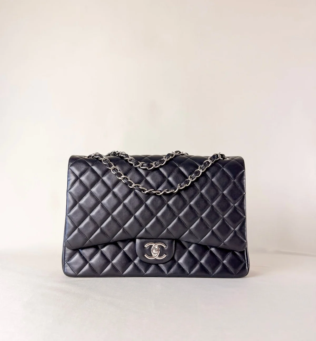 Front view of Chanel Classic Flap Maxi Jumbo Double Flap bag in black lambskin with palladium hardware