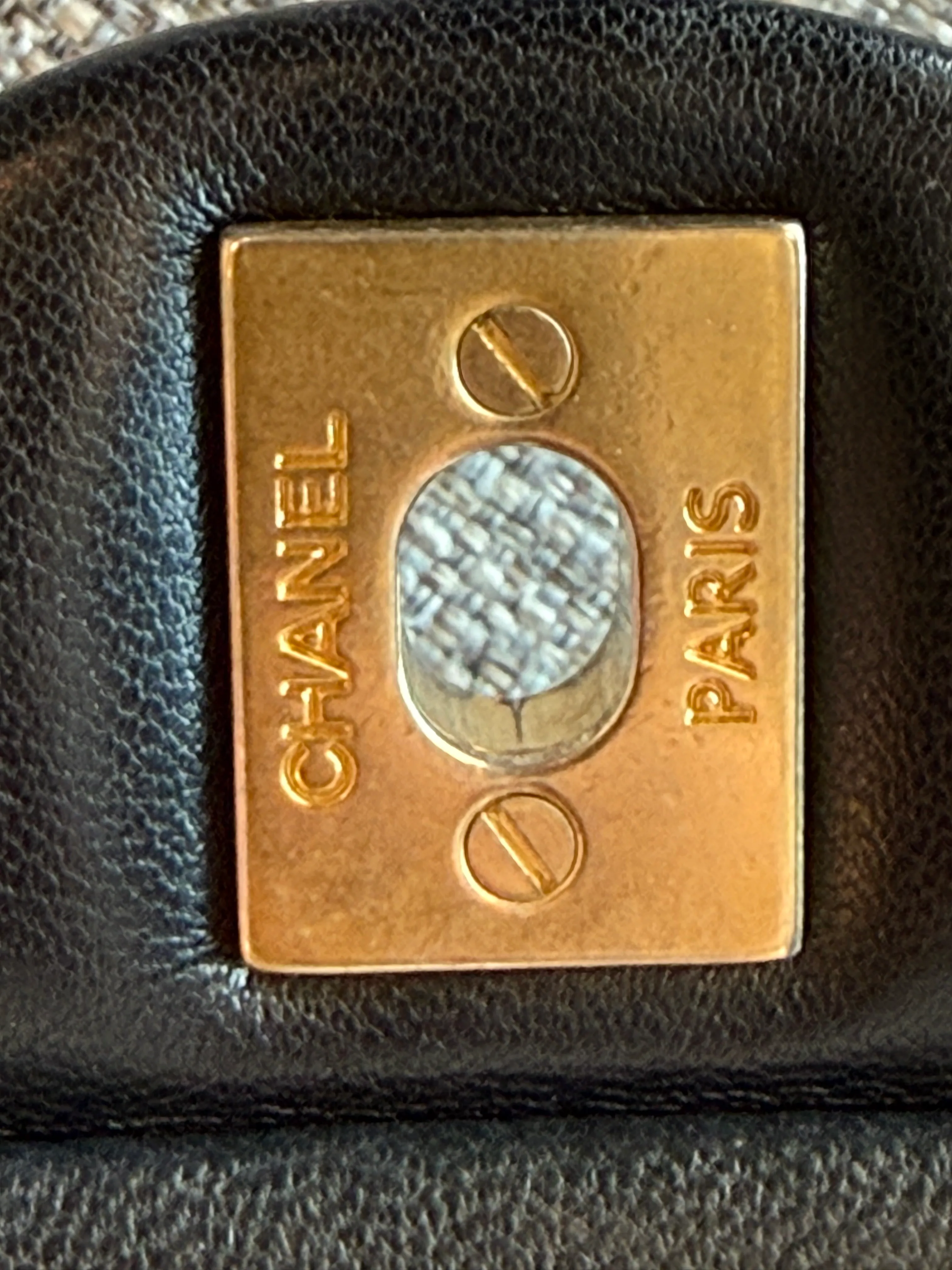 Chanel back plate close-up with flathead screws and engraved Chanel Paris stamp