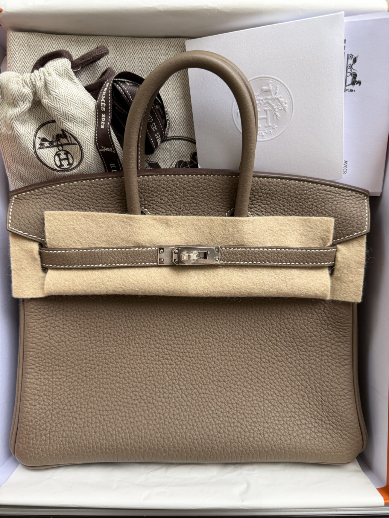 Hermès Birkin 25 Togo Etoupe palladium hardware – front view with protective packaging