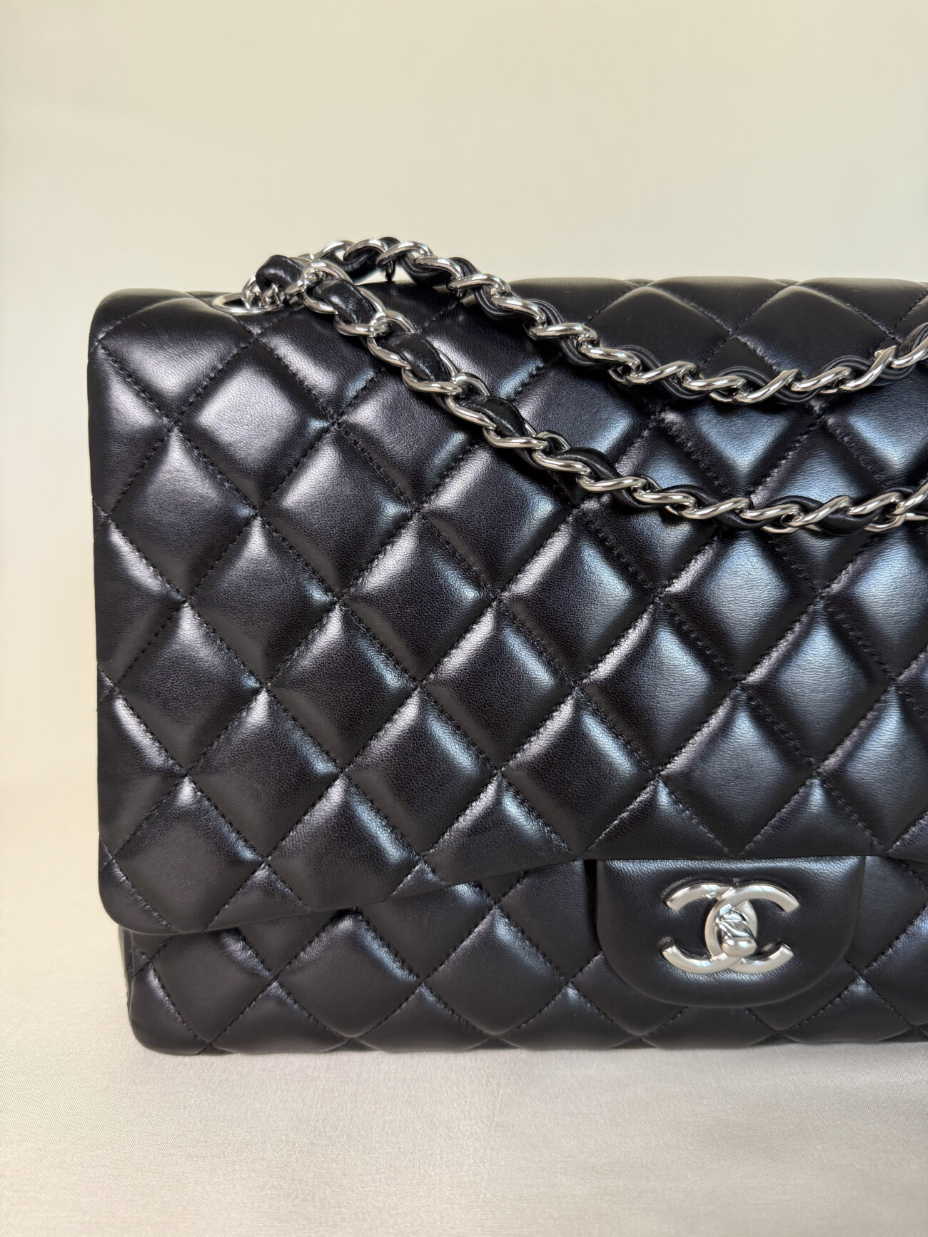 Chanel Maxi Single Flap bag black lambskin leather with palladium hardware front view with chain