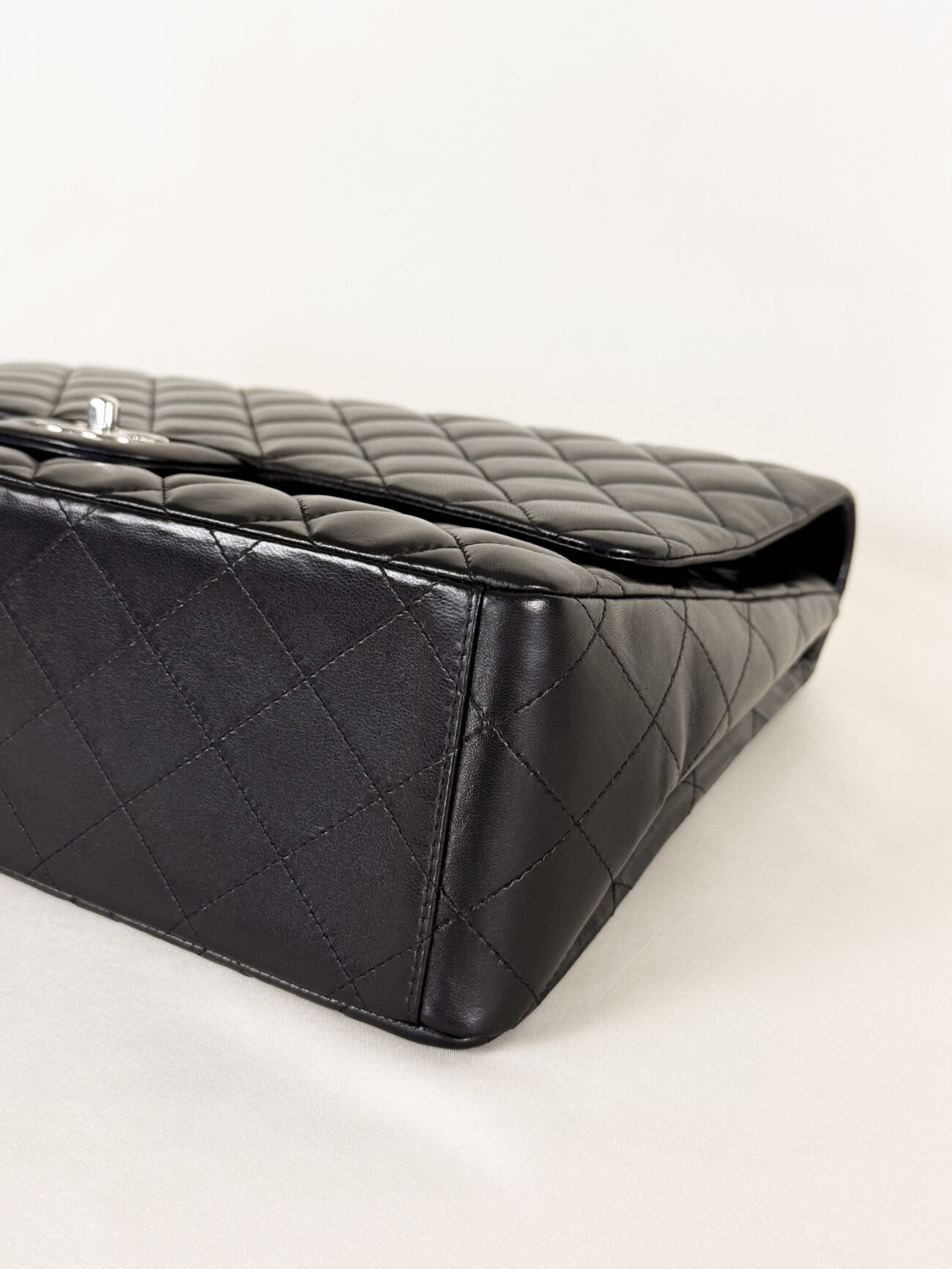 Chanel Maxi Single Flap bag black lambskin leather with palladium hardware bottom and corner detail