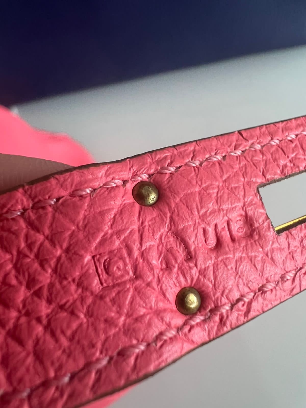 Close-up of the Hermès Birkin 35 Rose Azalée leather strap showing the embossed Hermès date stamp and stitching.