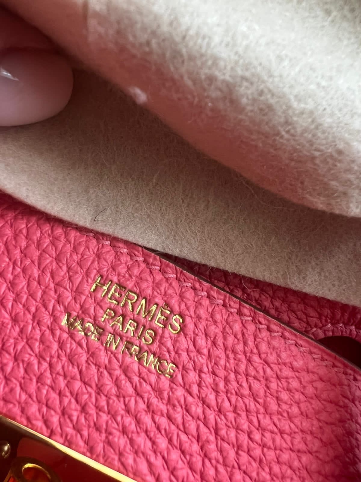 Close-up of the gold Hermès Paris Made in France stamp on the Rose Azalée grained leather of a Birkin 35 bag.