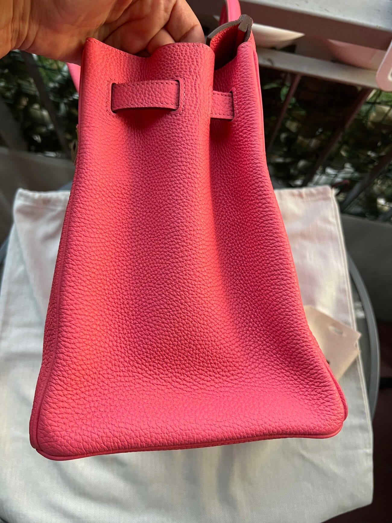 Side view of Hermès Birkin 35 Rose Azalée showing the pink grained leather, expandable side gusset and leather strap detail.