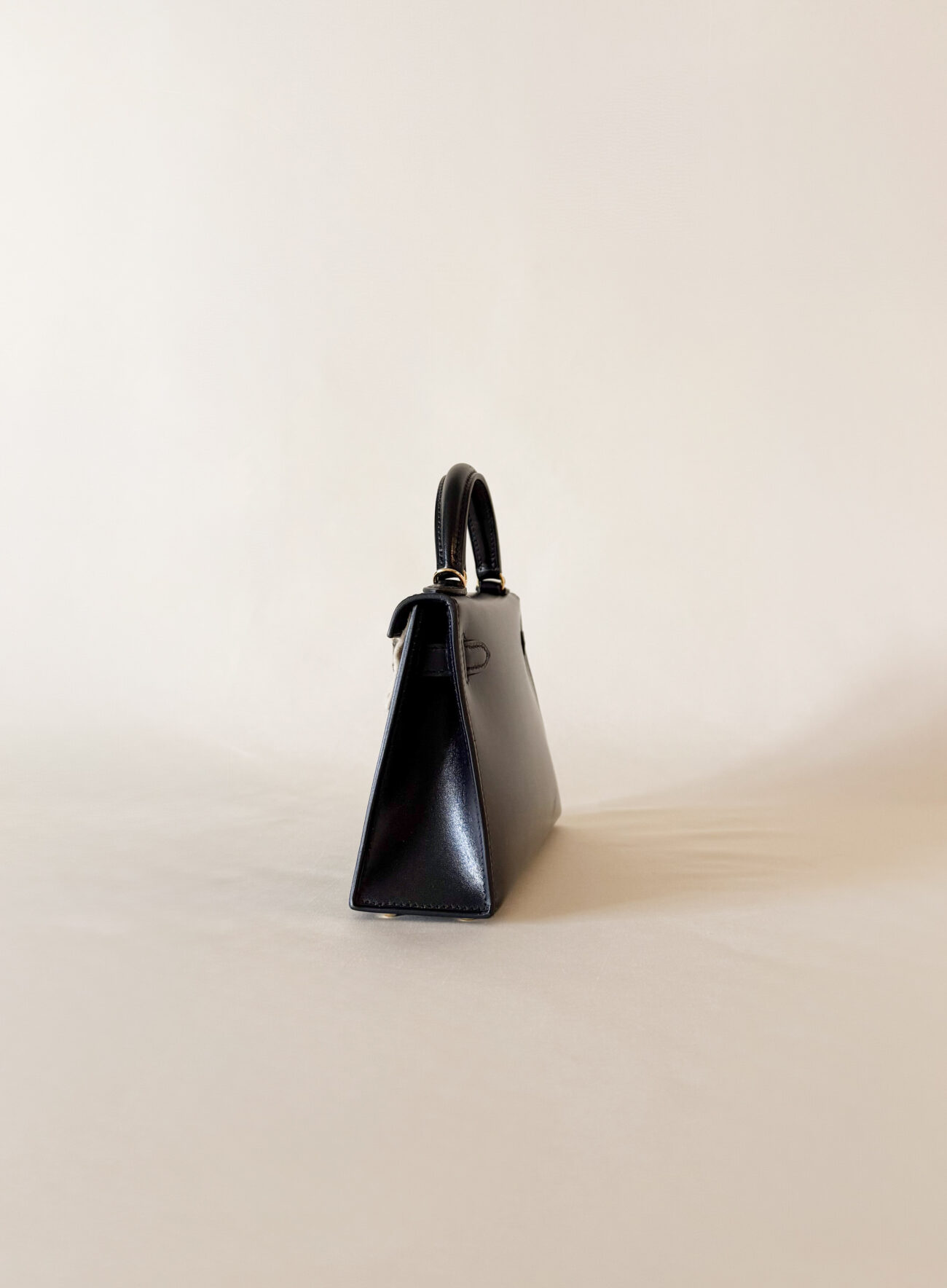 Hermès Mini Kelly box black leather with gold hardware side view
