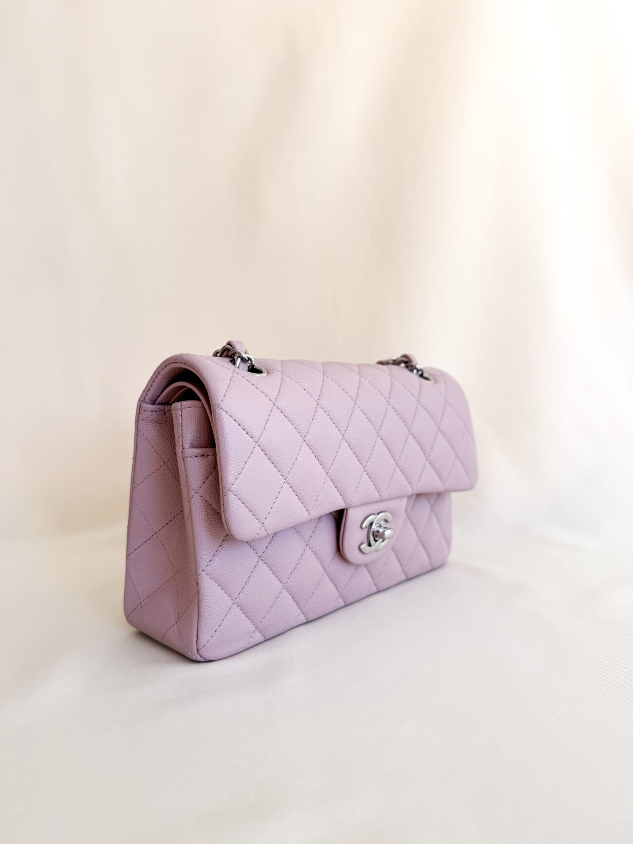 Chanel classic flap rose caviar leather palladium hardware angled side view