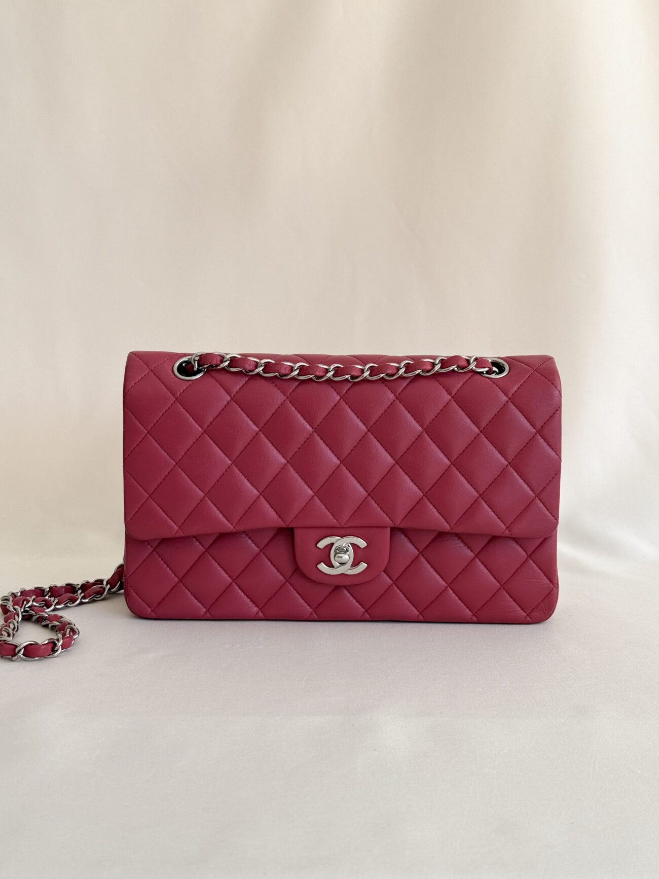 Chanel classic flap medium raspberry lambskin with palladium hardware front view with the chain