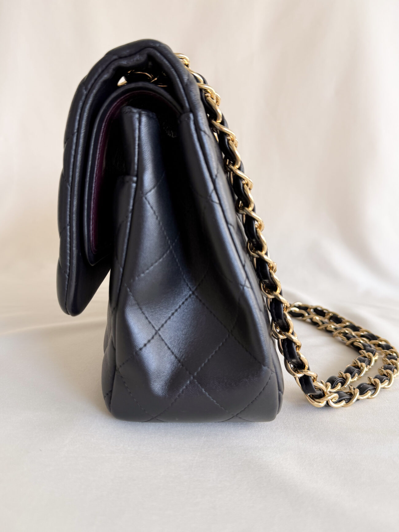 Chanel classic flap jumbo black lambskin leather with gold hardware side view structure