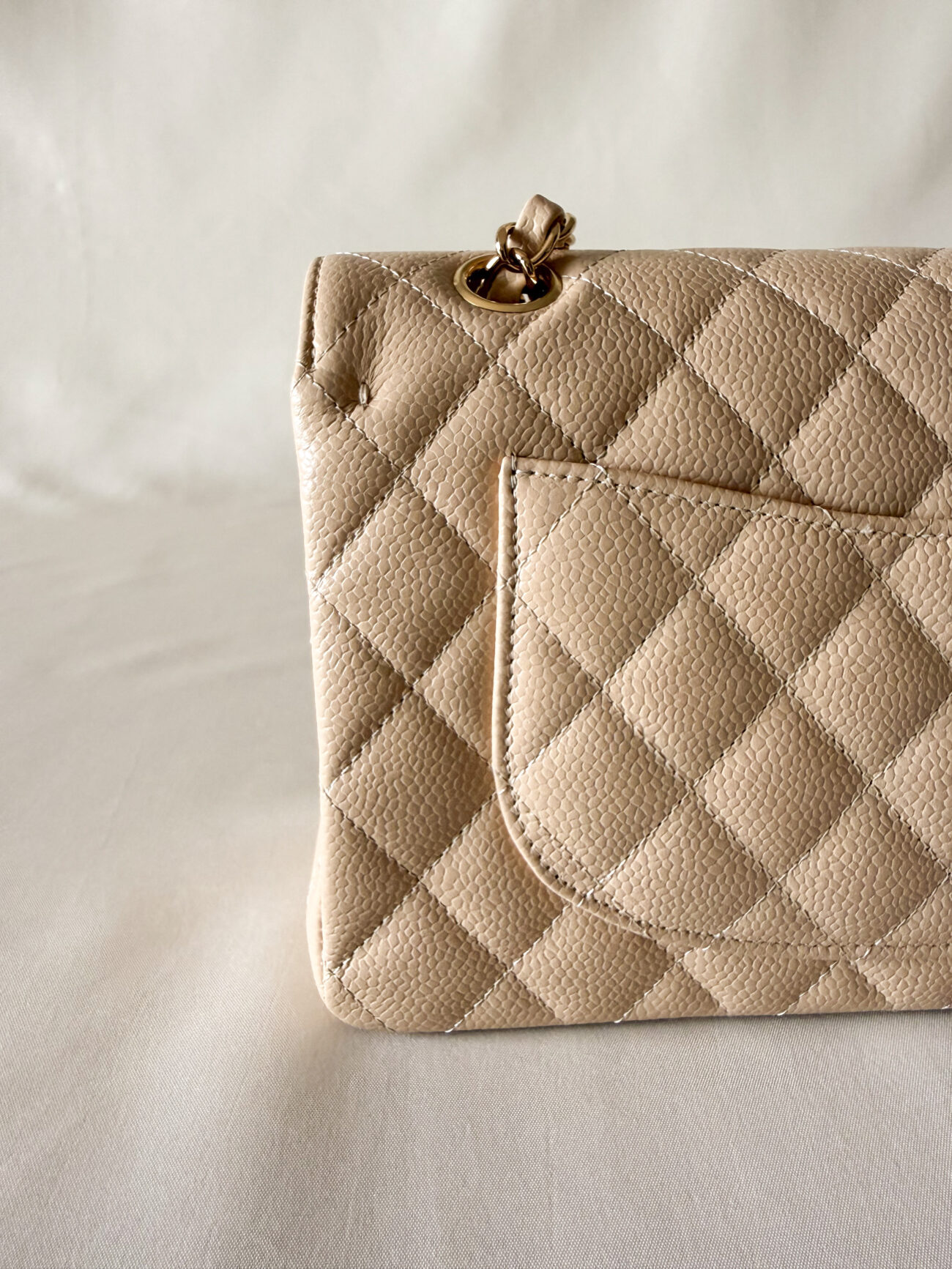 Chanel classic flap small beige caviar with gold hardware pocket profile detail