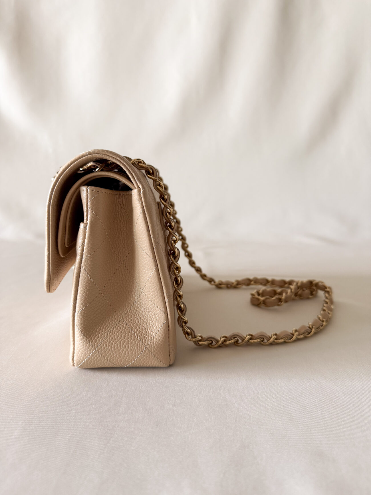 Chanel classic flap small beige caviar with gold hardware side view