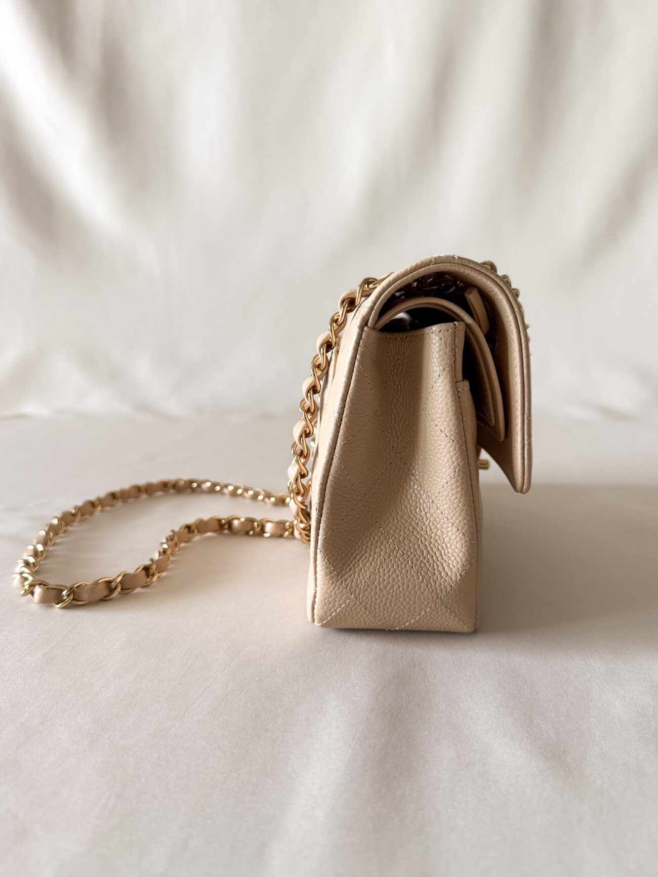 Chanel classic flap small beige caviar with gold hardware side profile detail