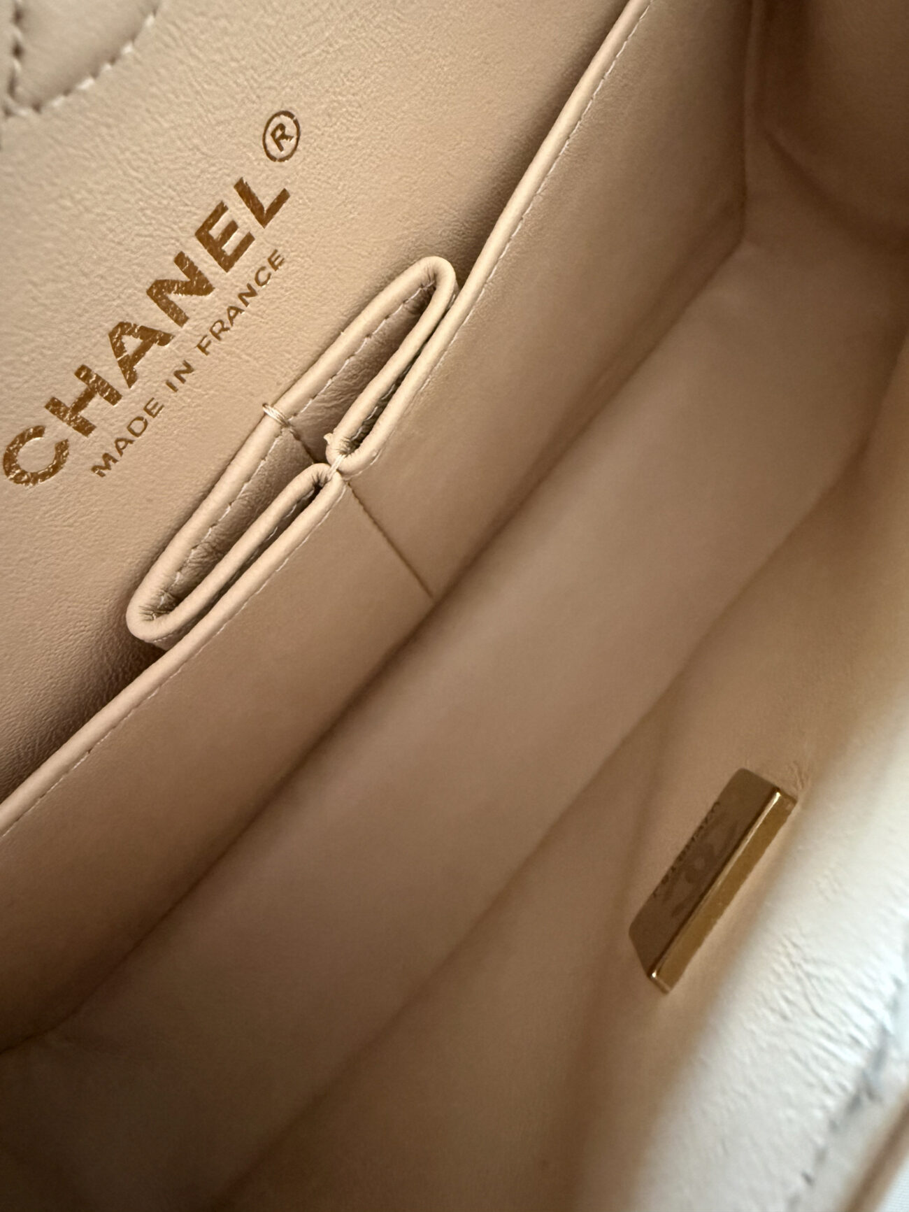 Chanel classic flap small beige caviar interior detail with double flap structure and smooth leather lining