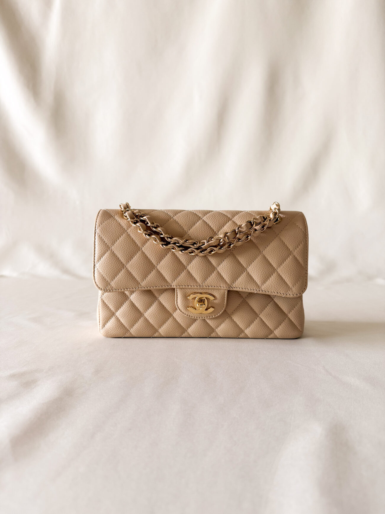 Chanel classic flap small beige caviar with gold hardware back pocket and chain detail view