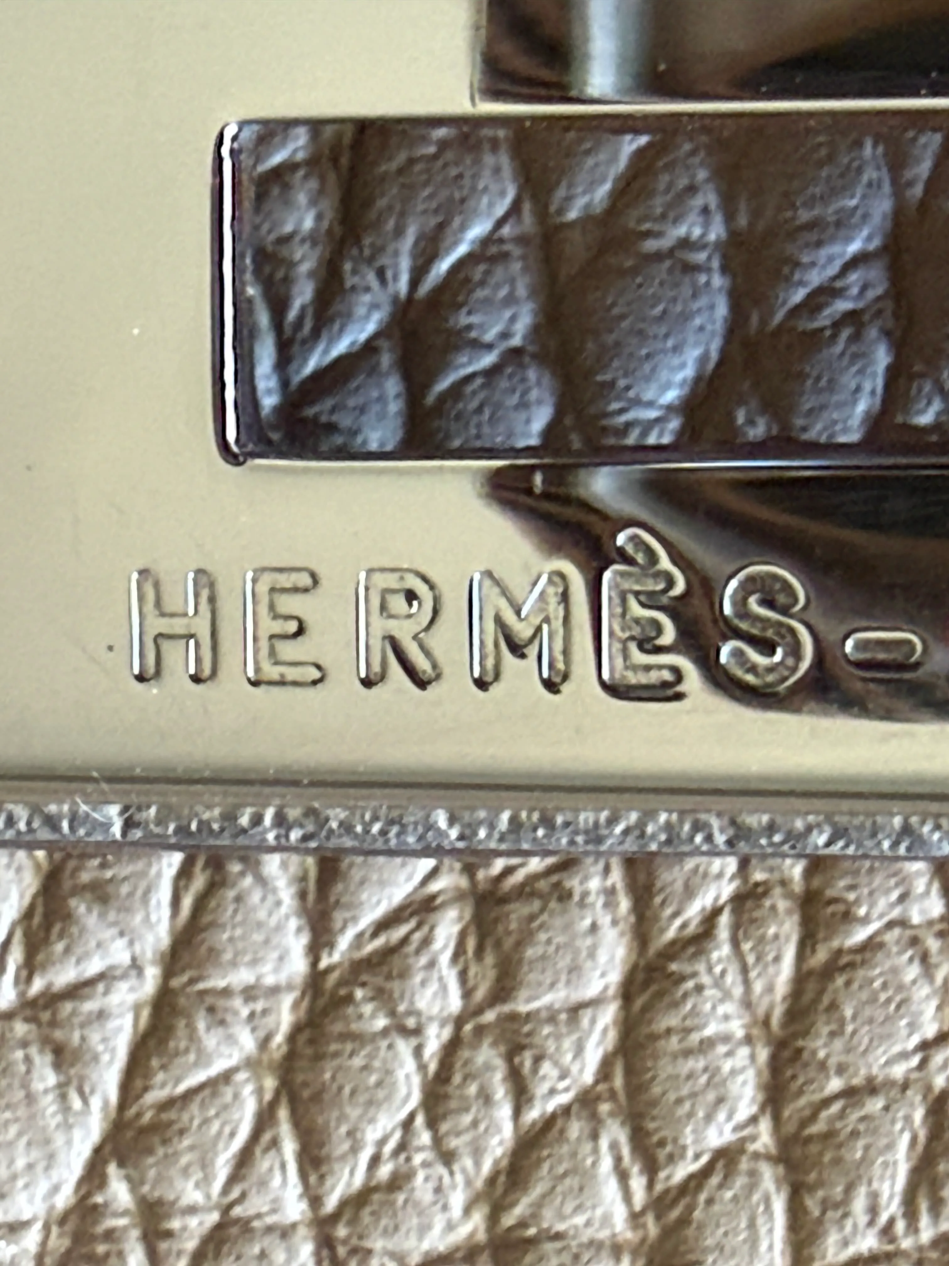 Close up vintage Hermès Birkin hardware engraving