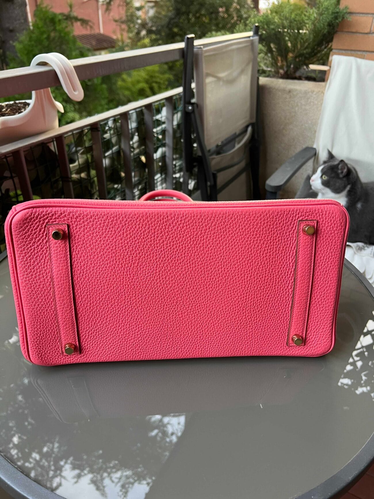 Bottom view of Hermès Birkin 35 Rose Azalée showing pink grained leather, four protective metal feet and stitching.