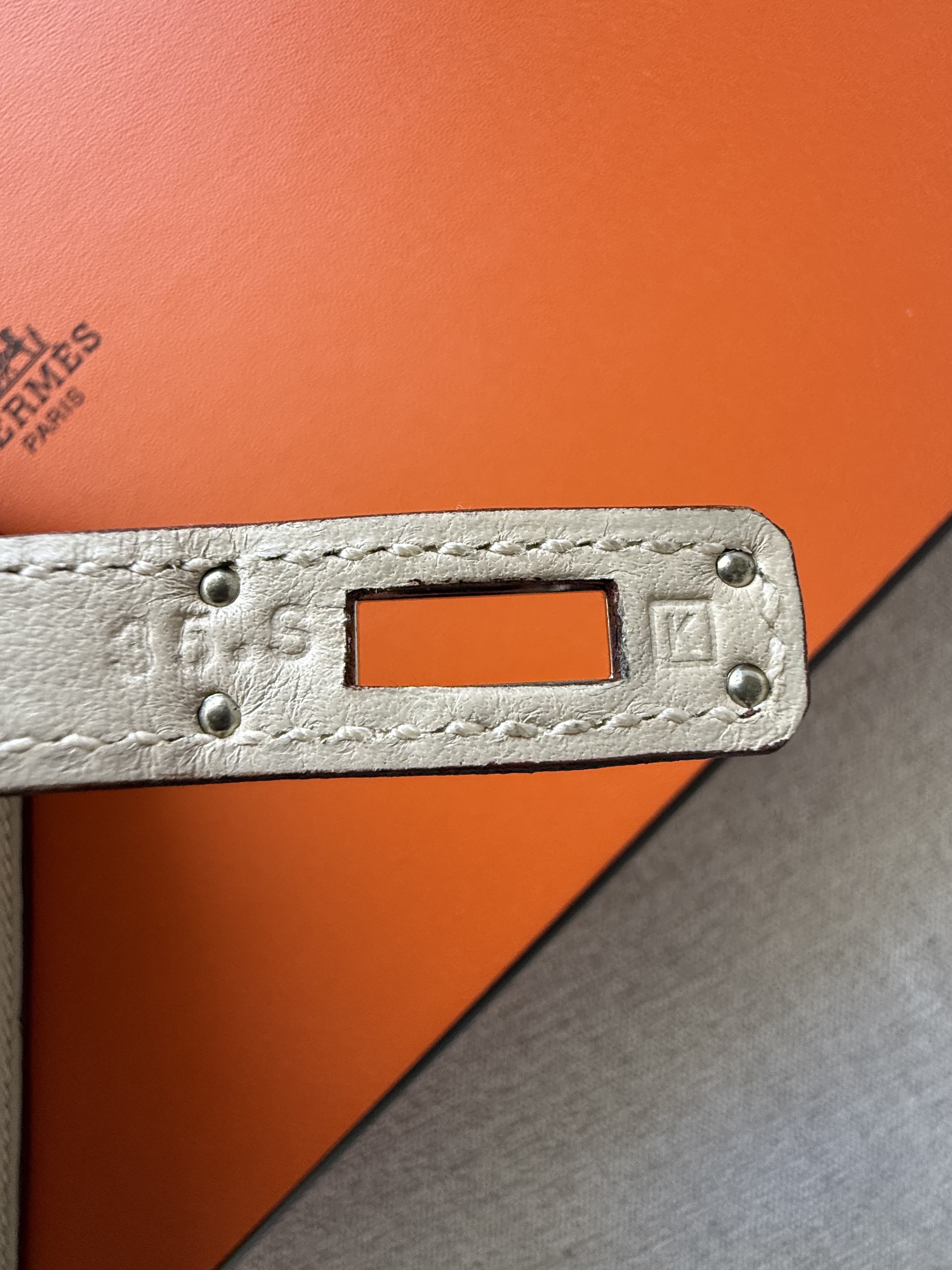 Pre-2014 Hermès Pochette blind stamp placement on the back of the right plaque with the Hermès Paris engraving