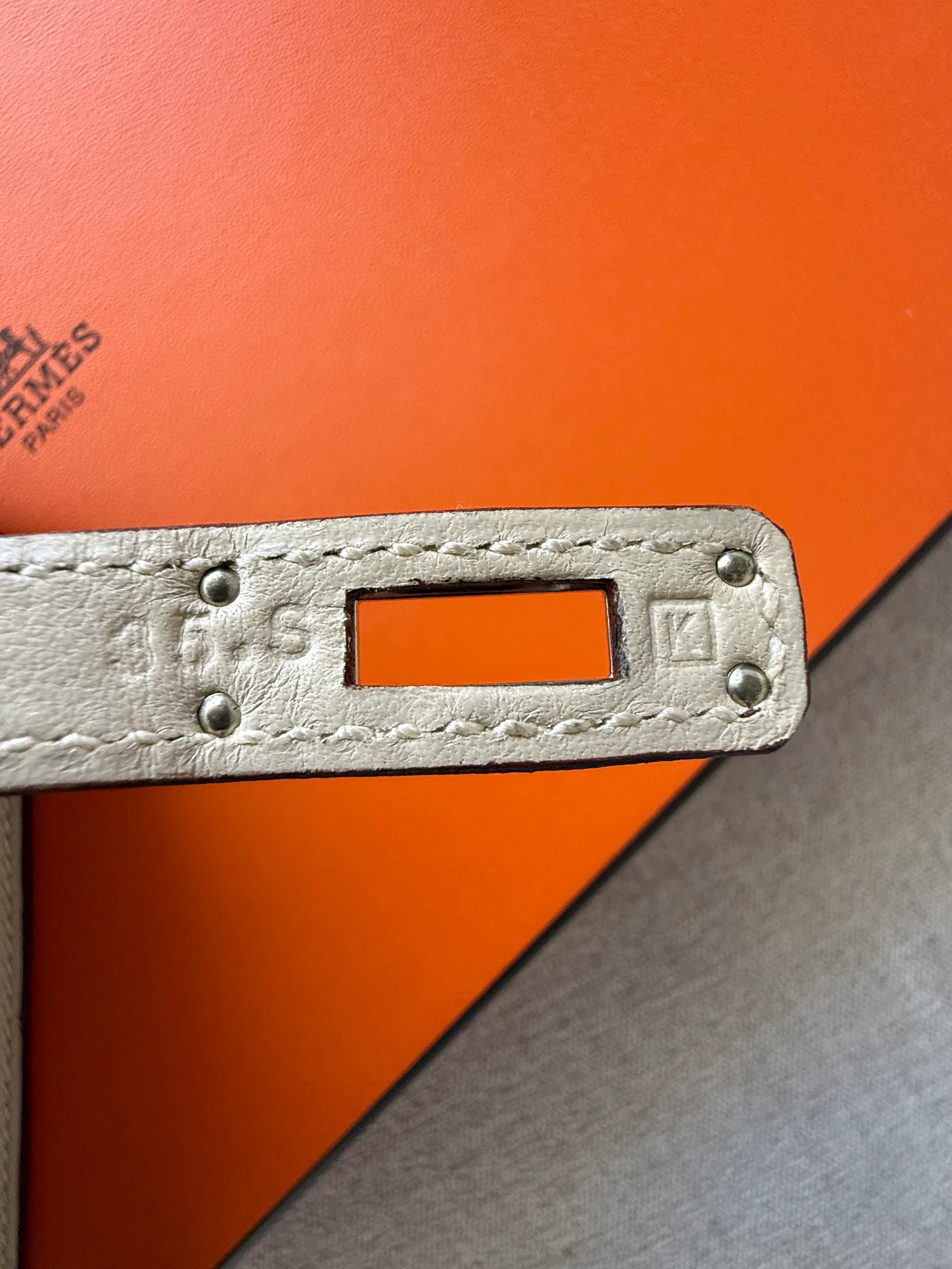 Pre-2014 Hermès Pochette blind stamp placement on the back of the right plaque with the Hermès Paris engraving