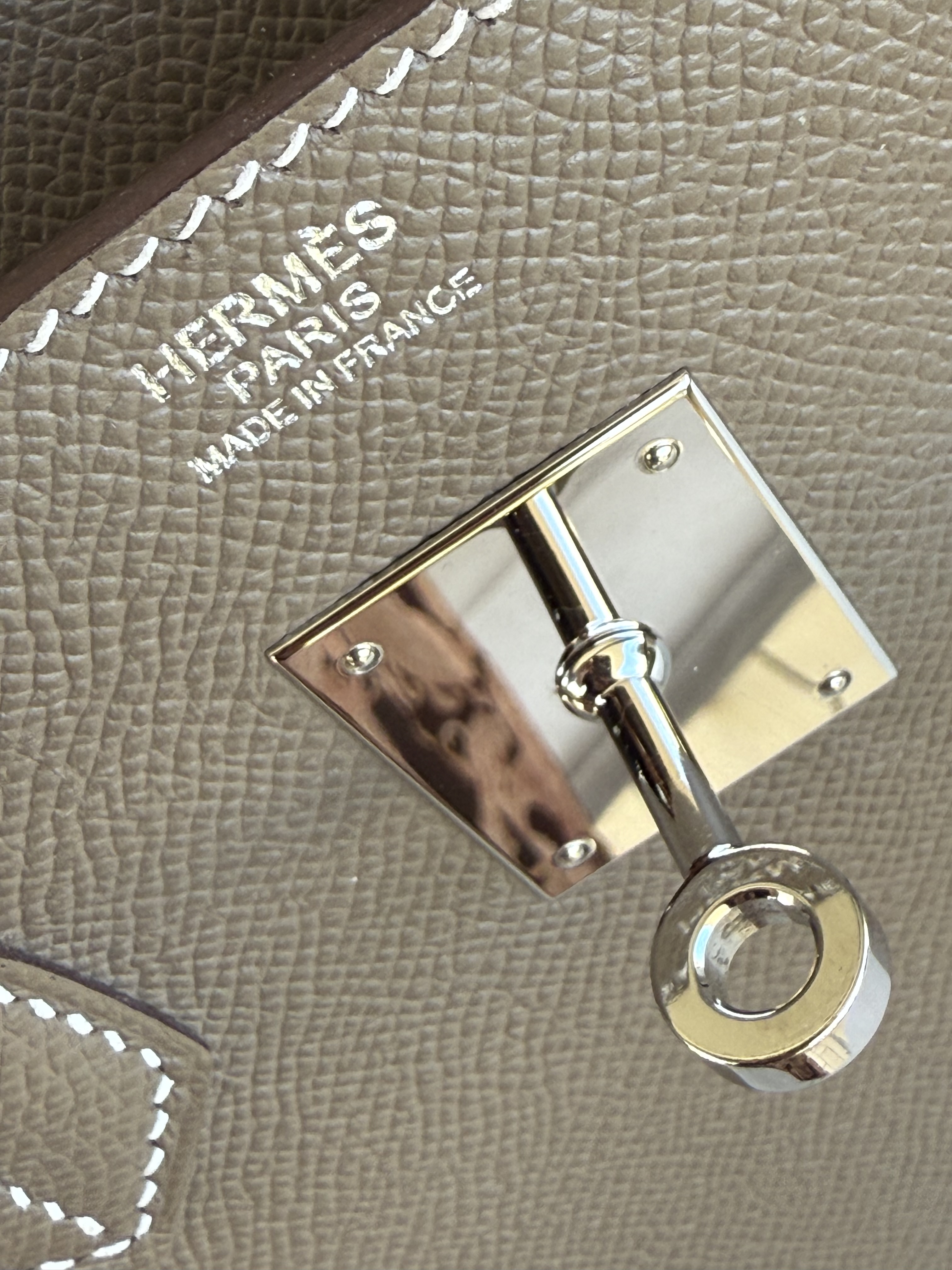 Hermès front stamp with palladium hardware above the interior plaque