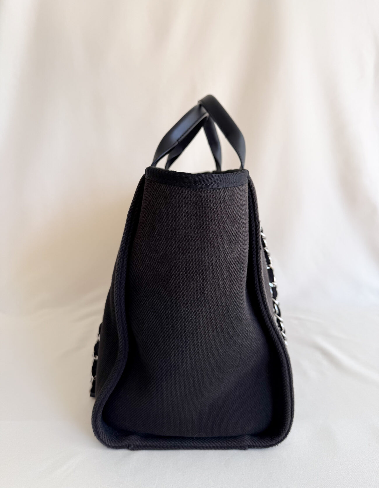 Chanel Deauville Tote Bag Large Black Canvas pearl logo four handles side view
