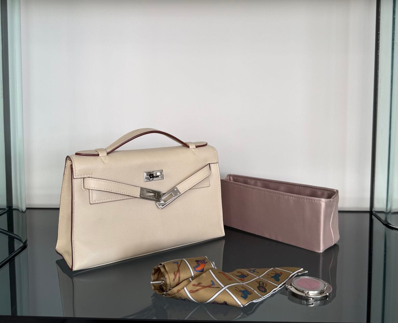 Hermès Kelly Pochette with Twilly scarf, organiser, bag hook and hardware protector.