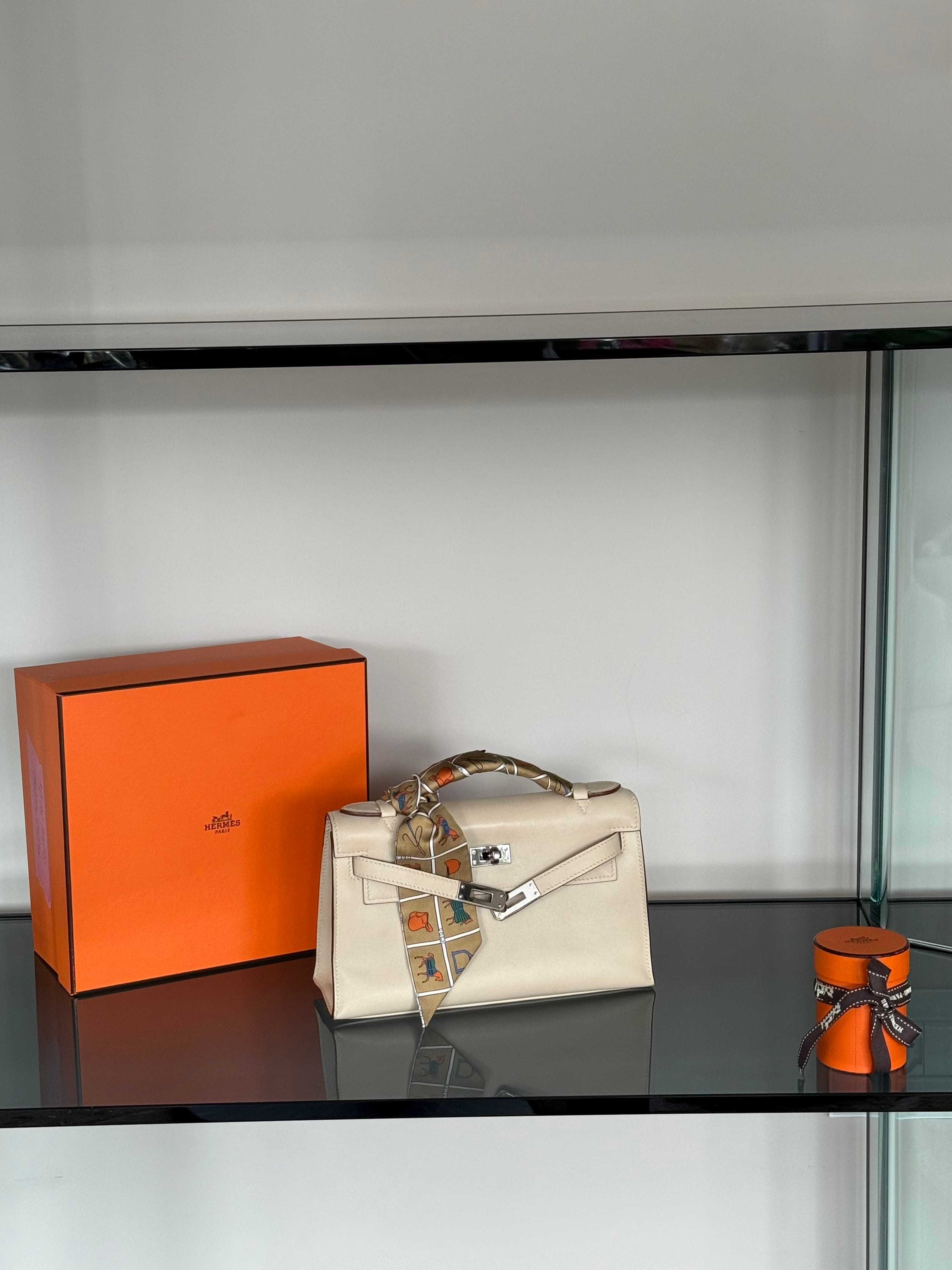 Hermès Kelly bag personalised with a colourful Twilly silk scarf