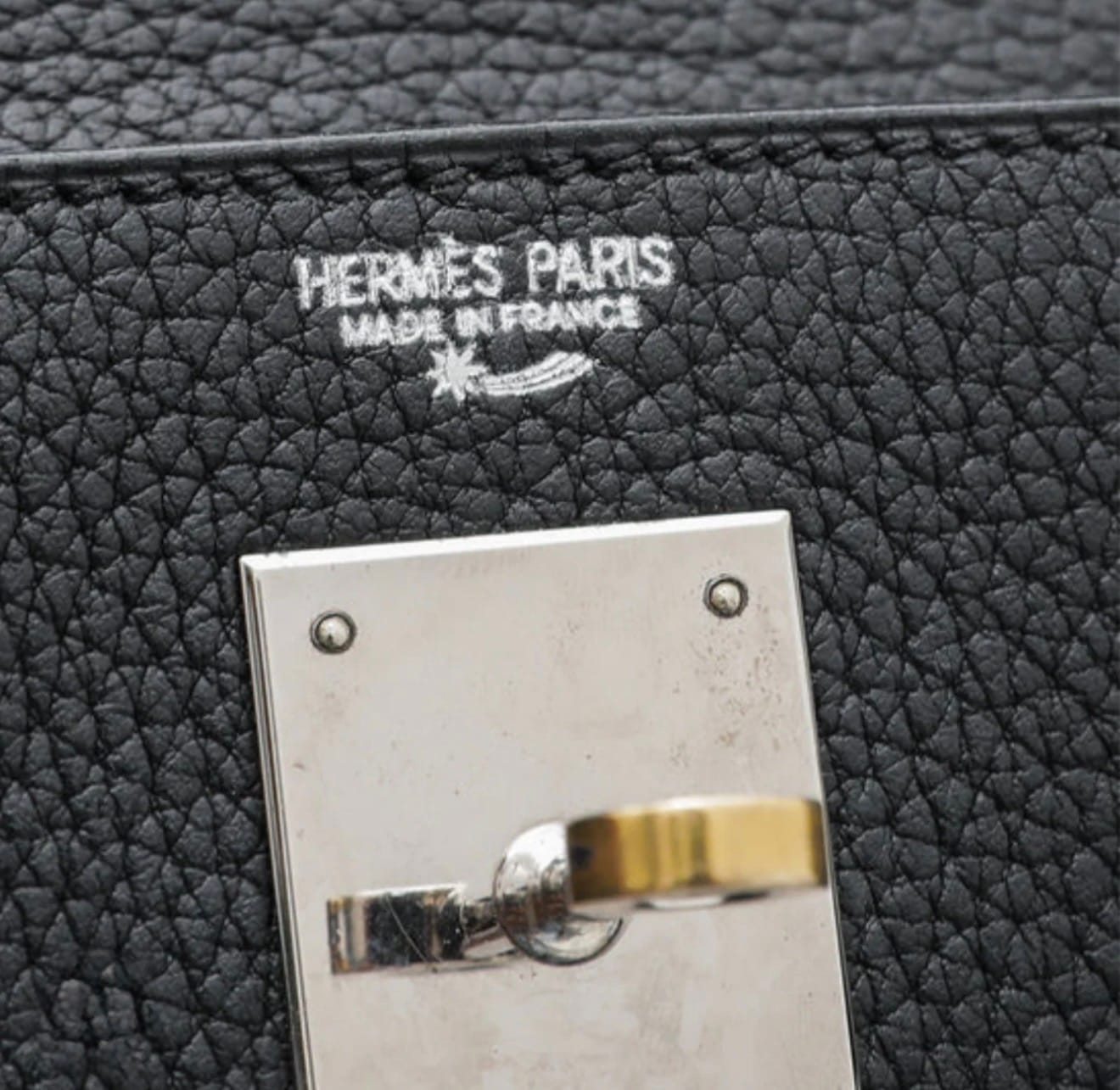 Hermès Shooting Star stamp symbol on an authentic Hermès bag.