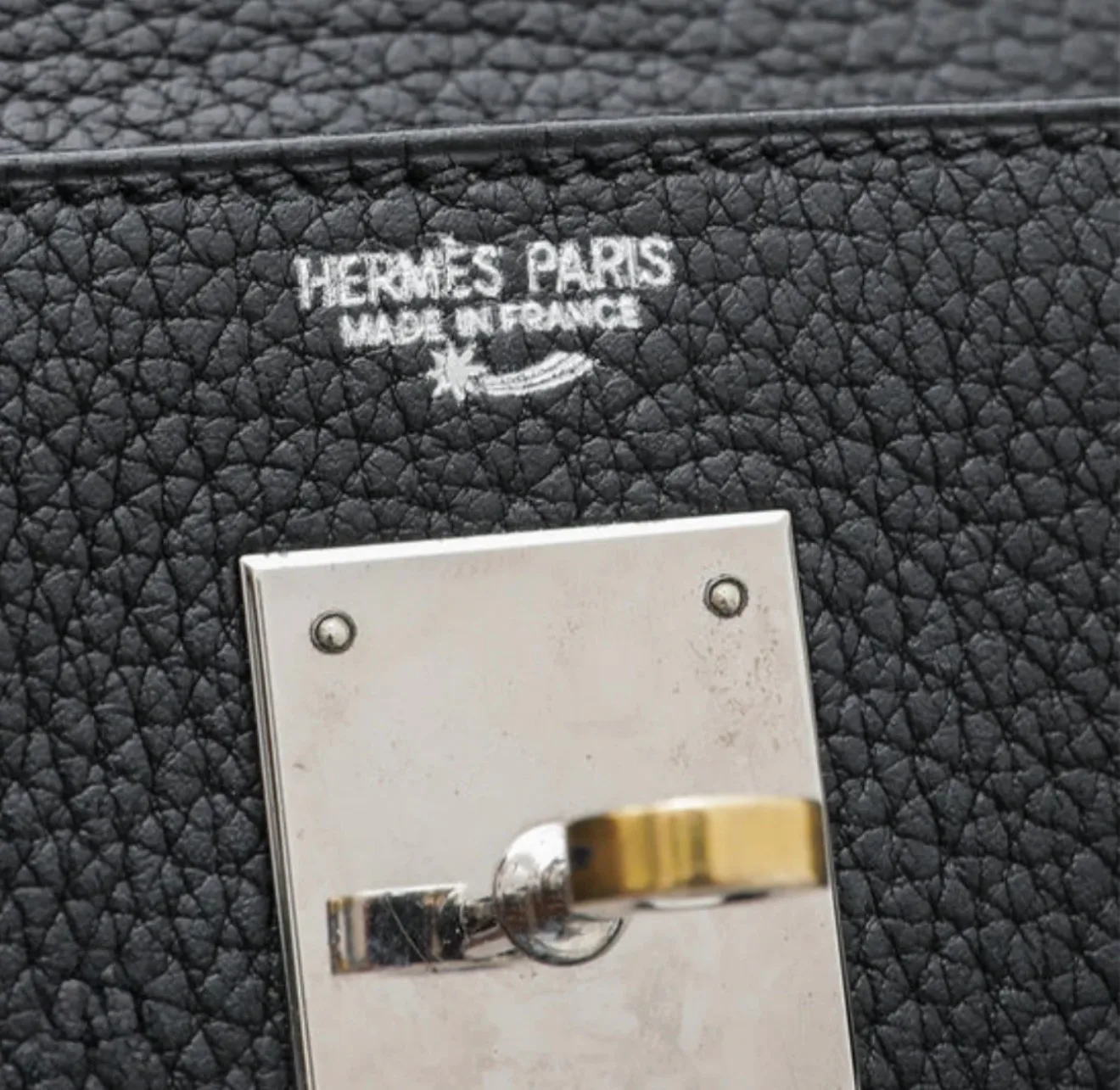 Hermès Shooting Star stamp symbol on an authentic Hermès bag.