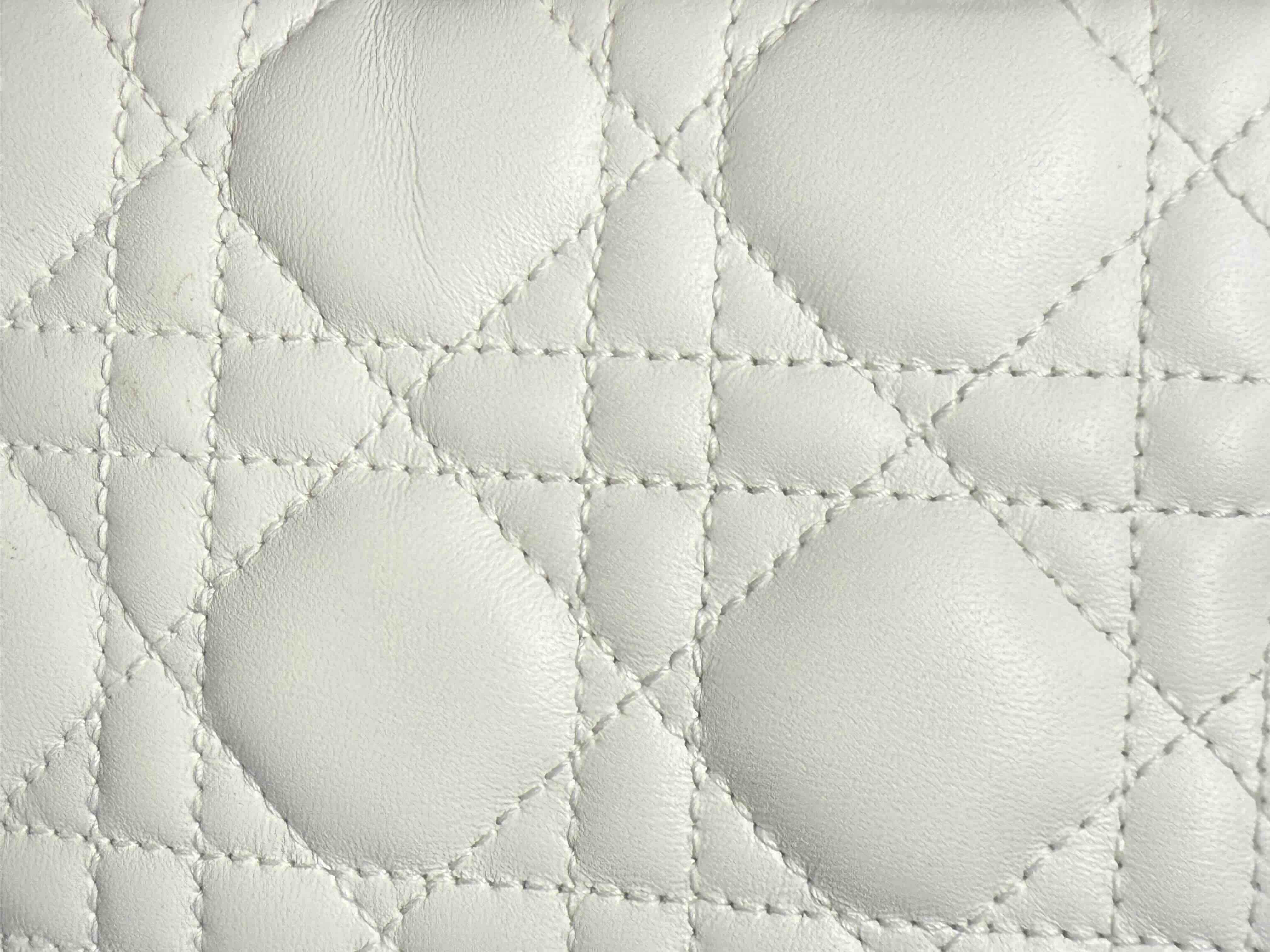 Close-up of Lady Dior Cannage stitching showing authentic leather and stitching details.