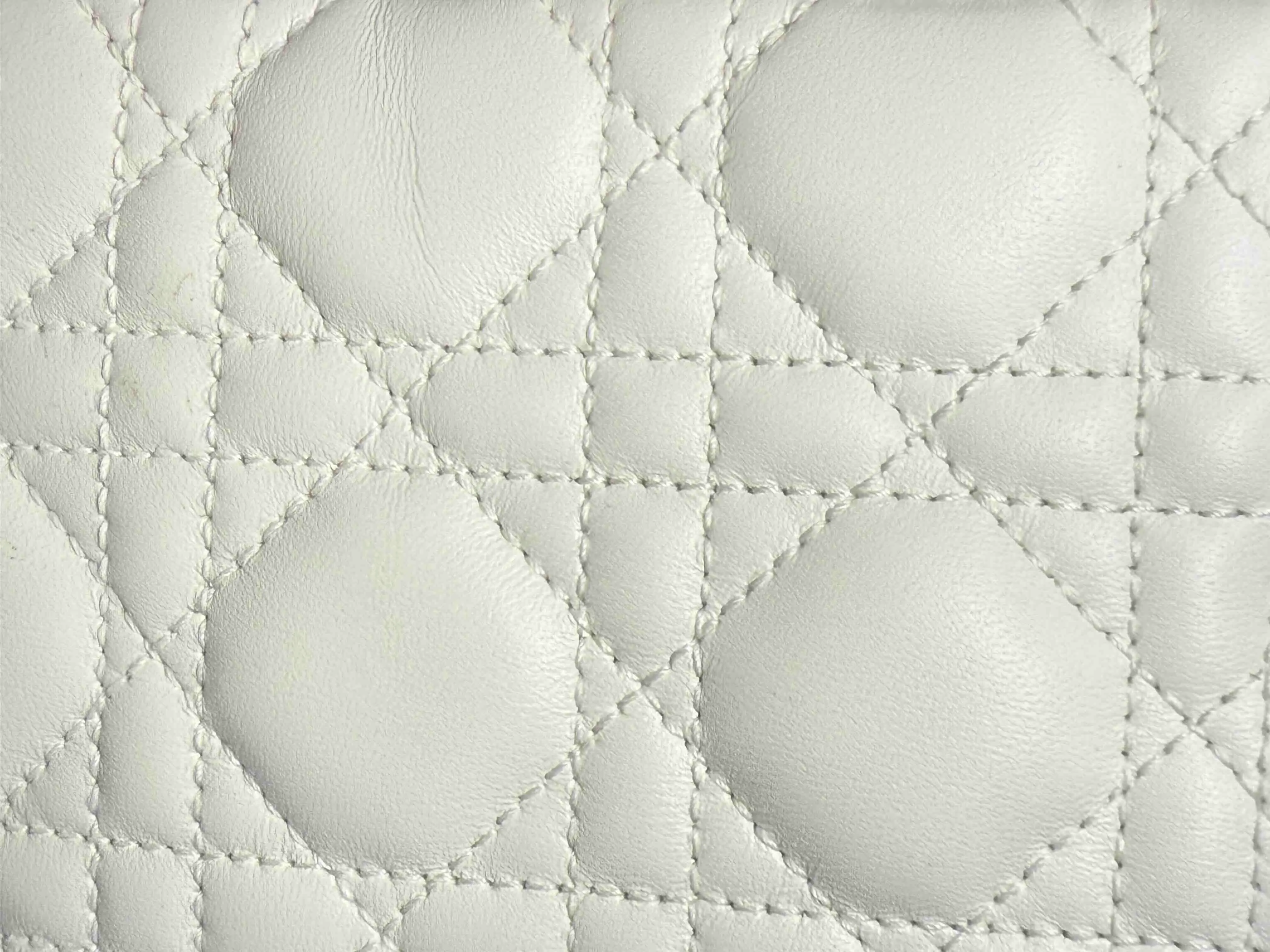 Close-up of Lady Dior Cannage stitching showing authentic leather and stitching details.