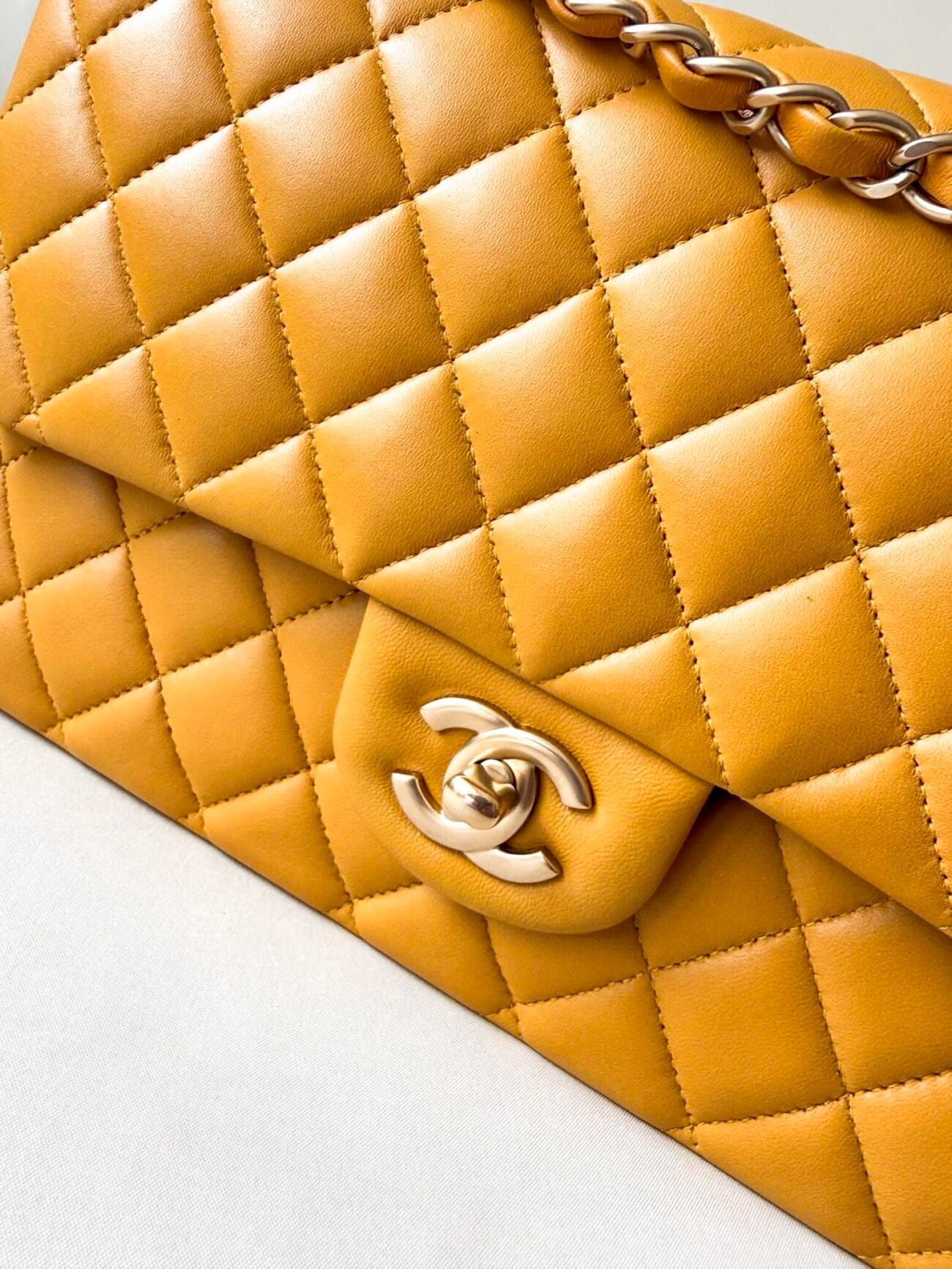Chanel Classic Flap Medium champagne hardware lock plate close-up