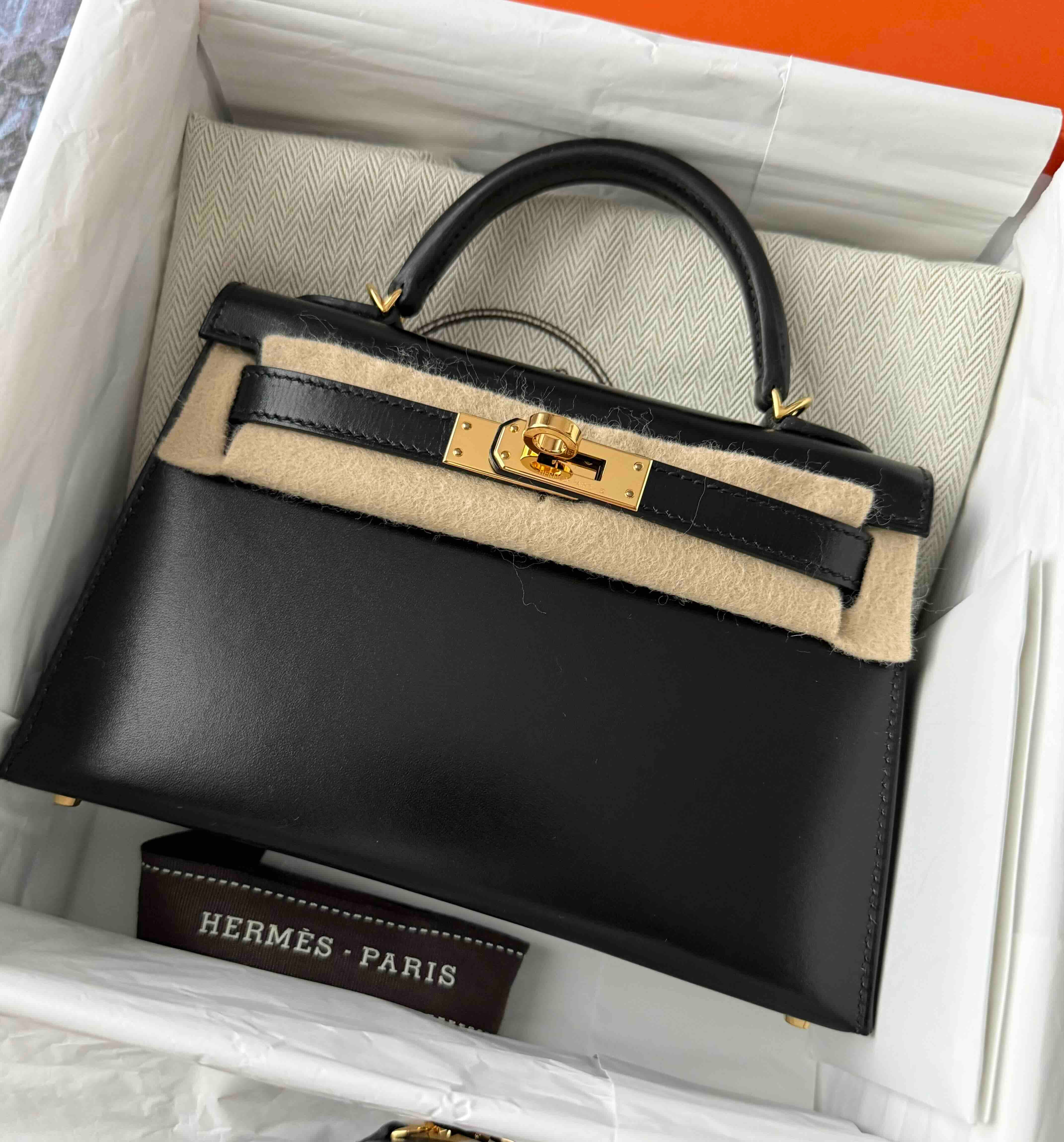 Hermès bag crafted from Box Calf leather showing its smooth glossy finish and elegant structured appearance.