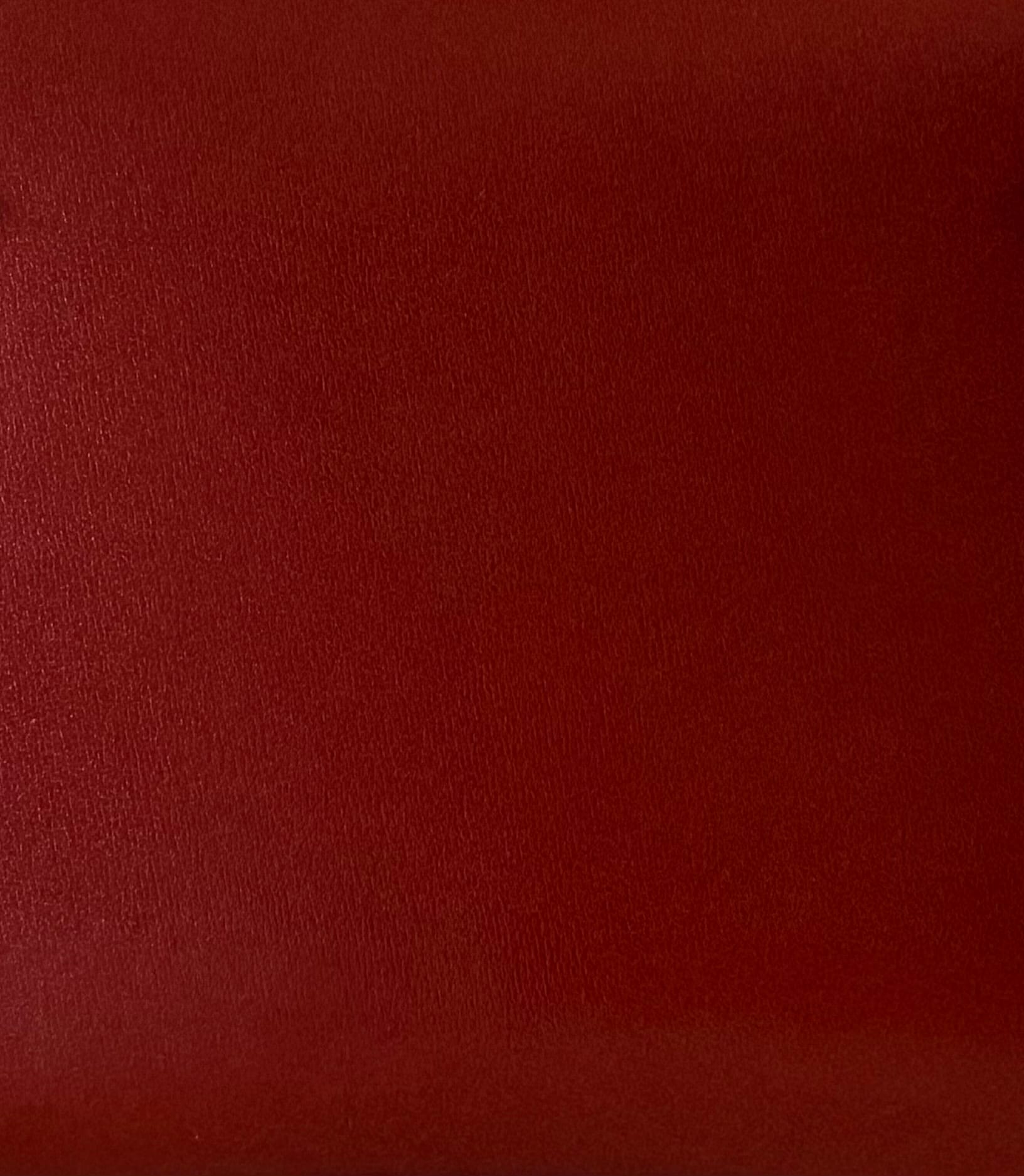 Close-up of Hermès Box Calf leather showing its smooth surface, glossy finish and almost invisible grain.
