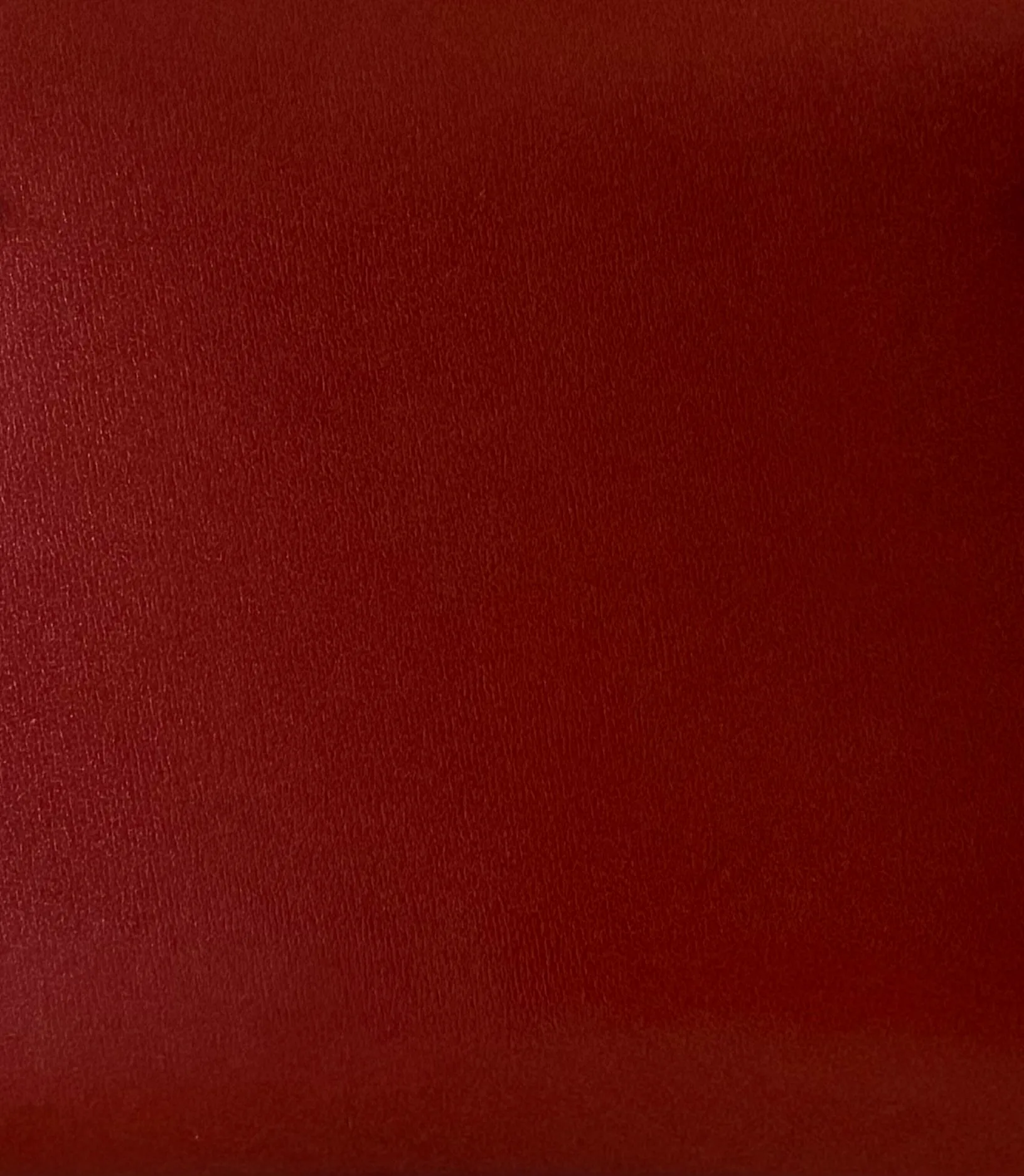 Close-up of Hermès Box Calf leather showing its smooth surface, glossy finish and almost invisible grain.