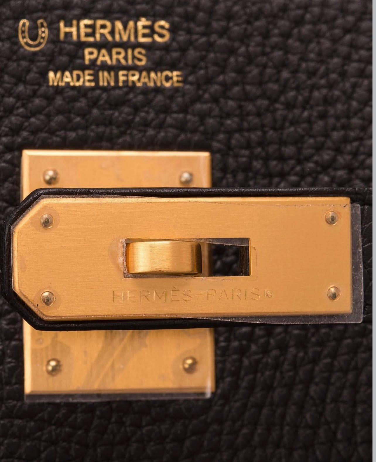 Close-up of Hermès Brushed Gold Hardware (BGHW) turn-lock closure
