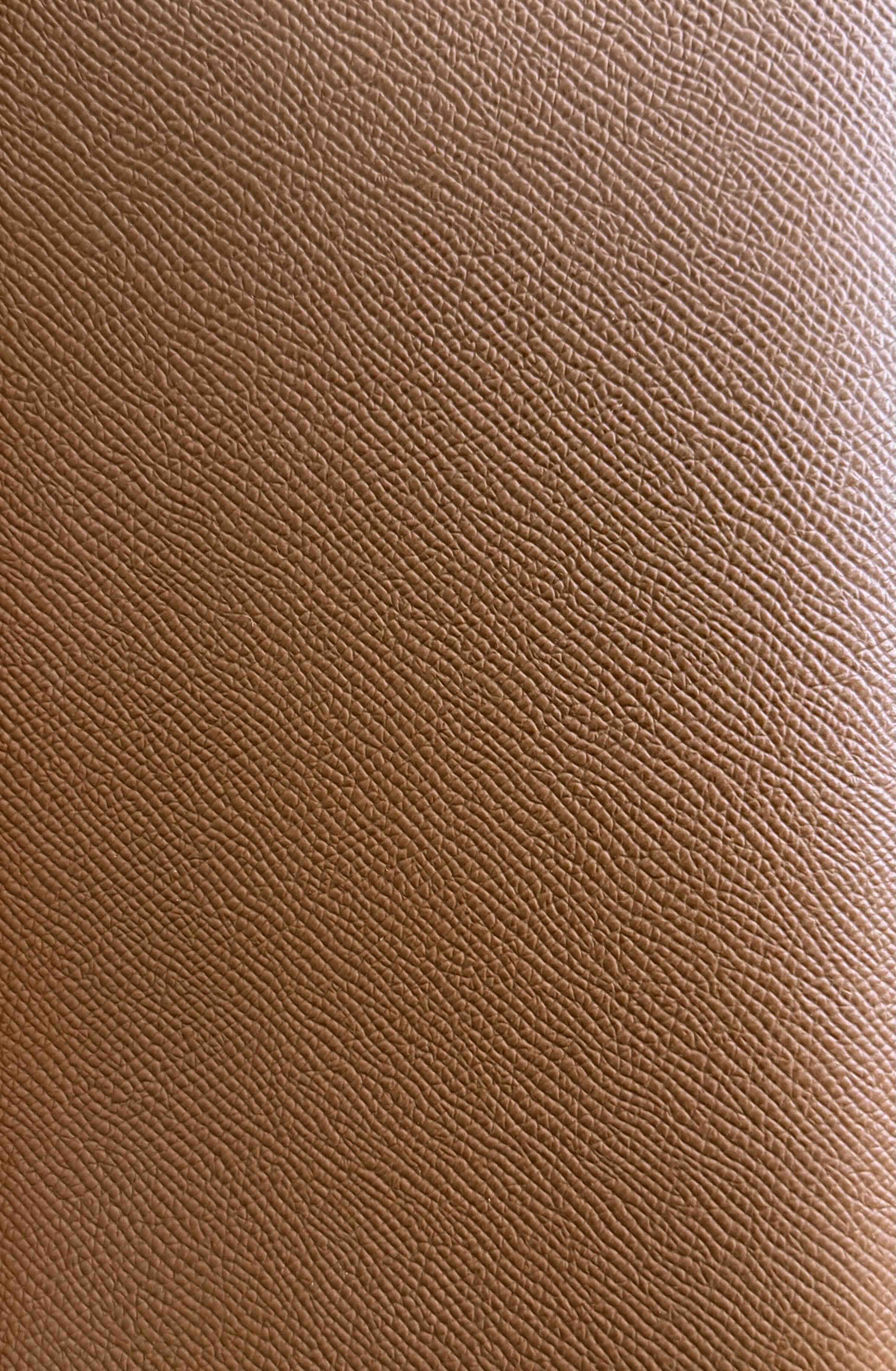 Close-up of Hermès Epsom leather showing its embossed grain and rigid texture on a Birkin bag.