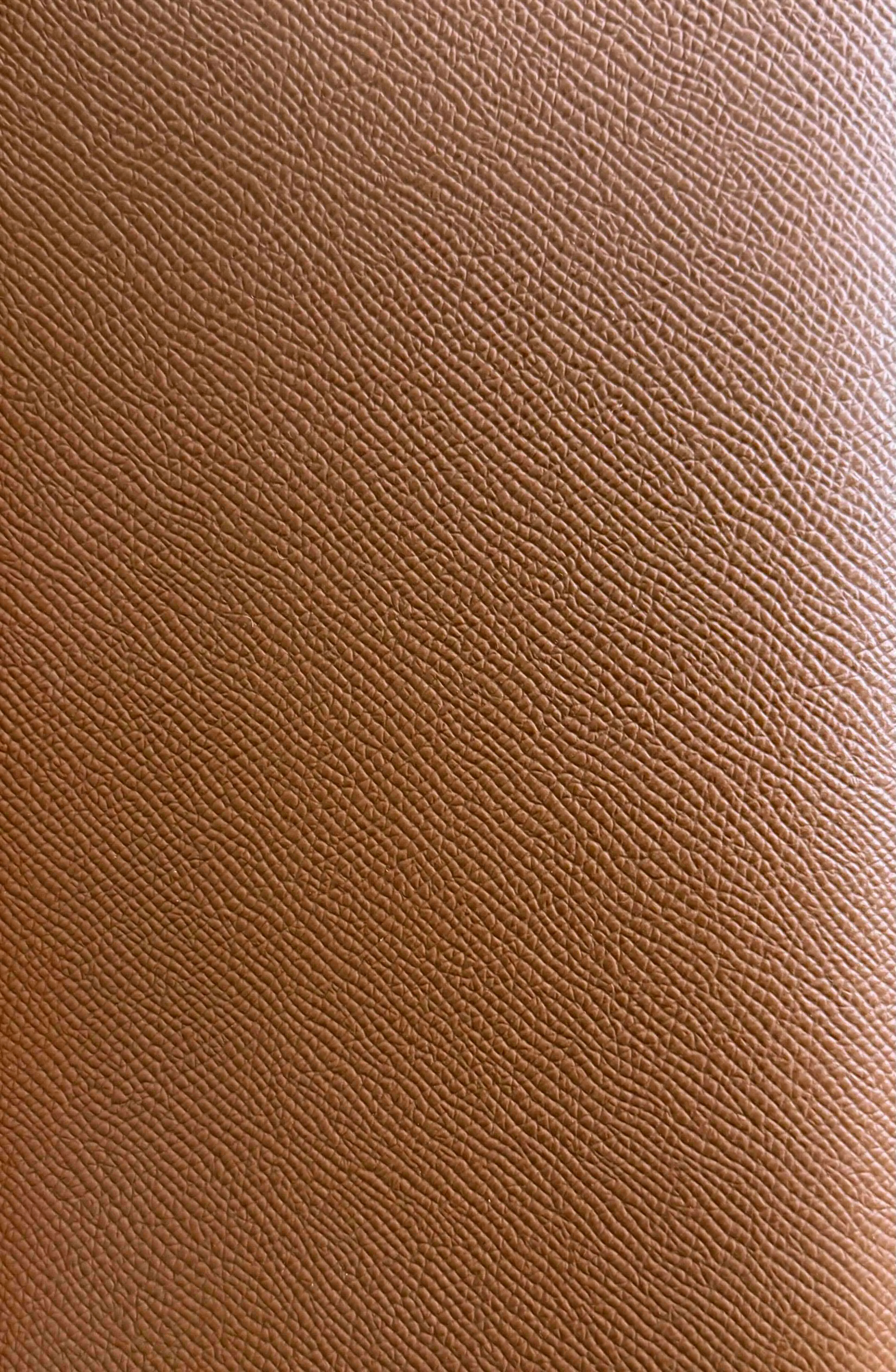 Close-up of Hermès Epsom leather showing its embossed grain and rigid texture on a Birkin bag.