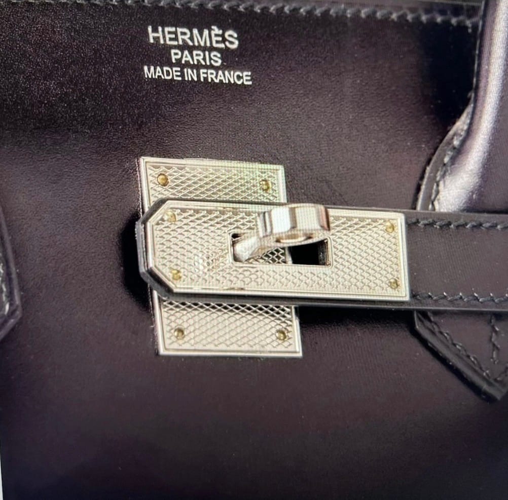 Close-up of Hermès Guilloché Hardware turn-lock closure