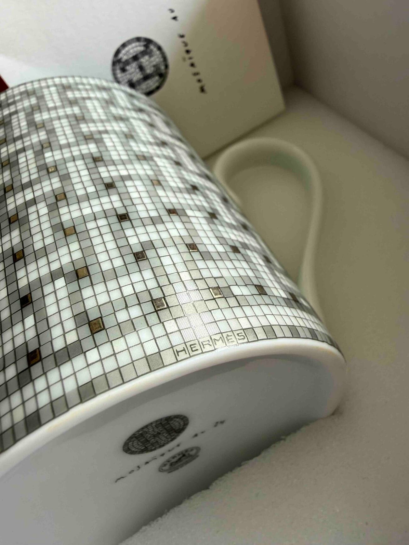 Close-up of Hermès logo on Mosaique au 24 Platinum porcelain mug