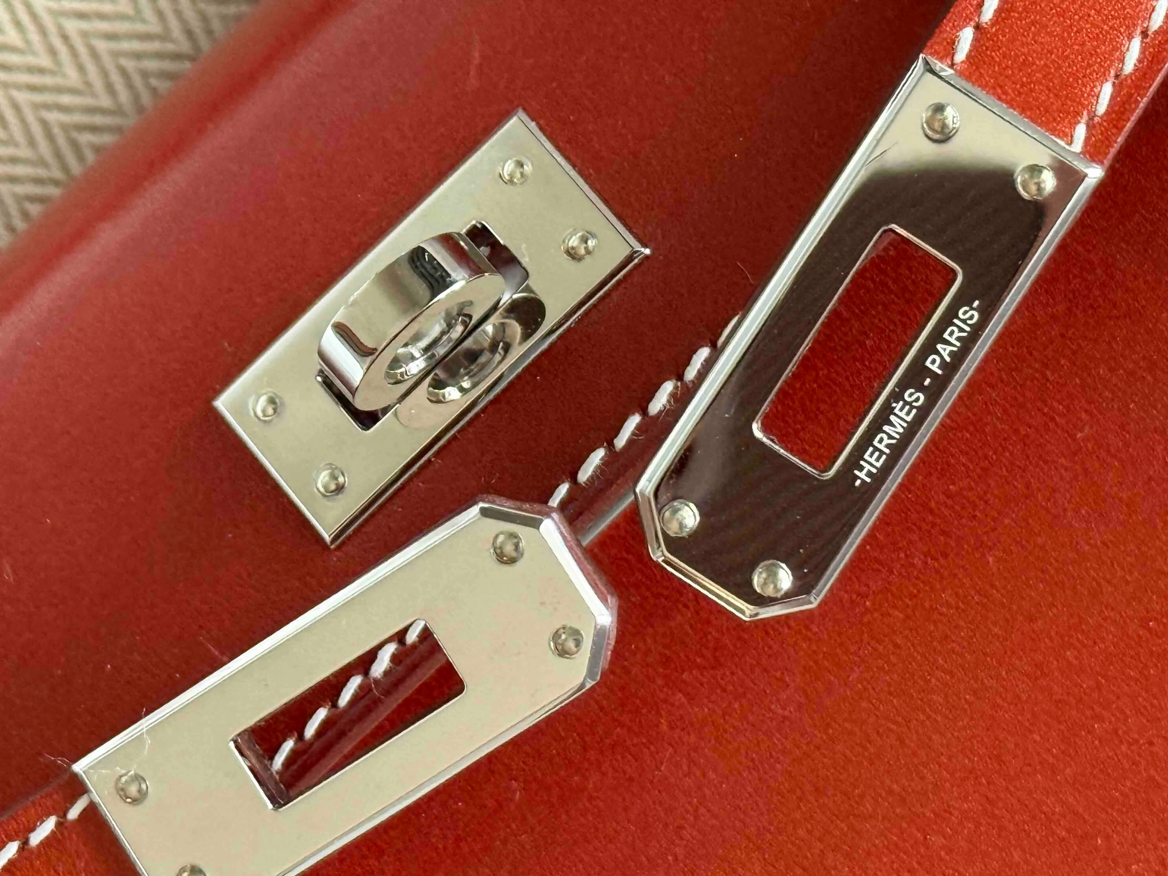 Close-up of Hermès Gold Hardware (GHW) Kelly turn-lock closure