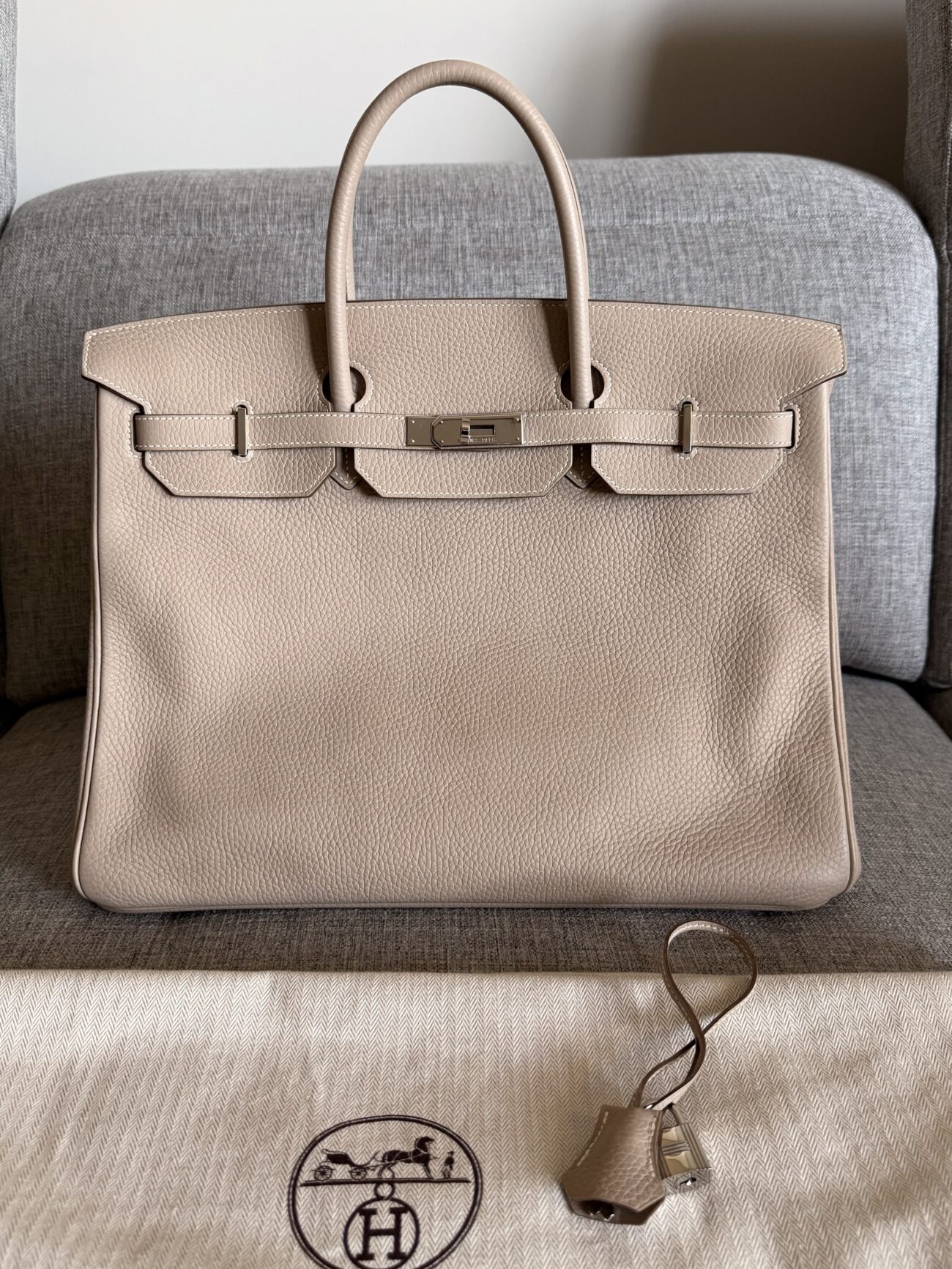 Hermès Birkin 40 in Argile Clémence leather with palladium hardware, front view with Hermès dust bag and clochette.
