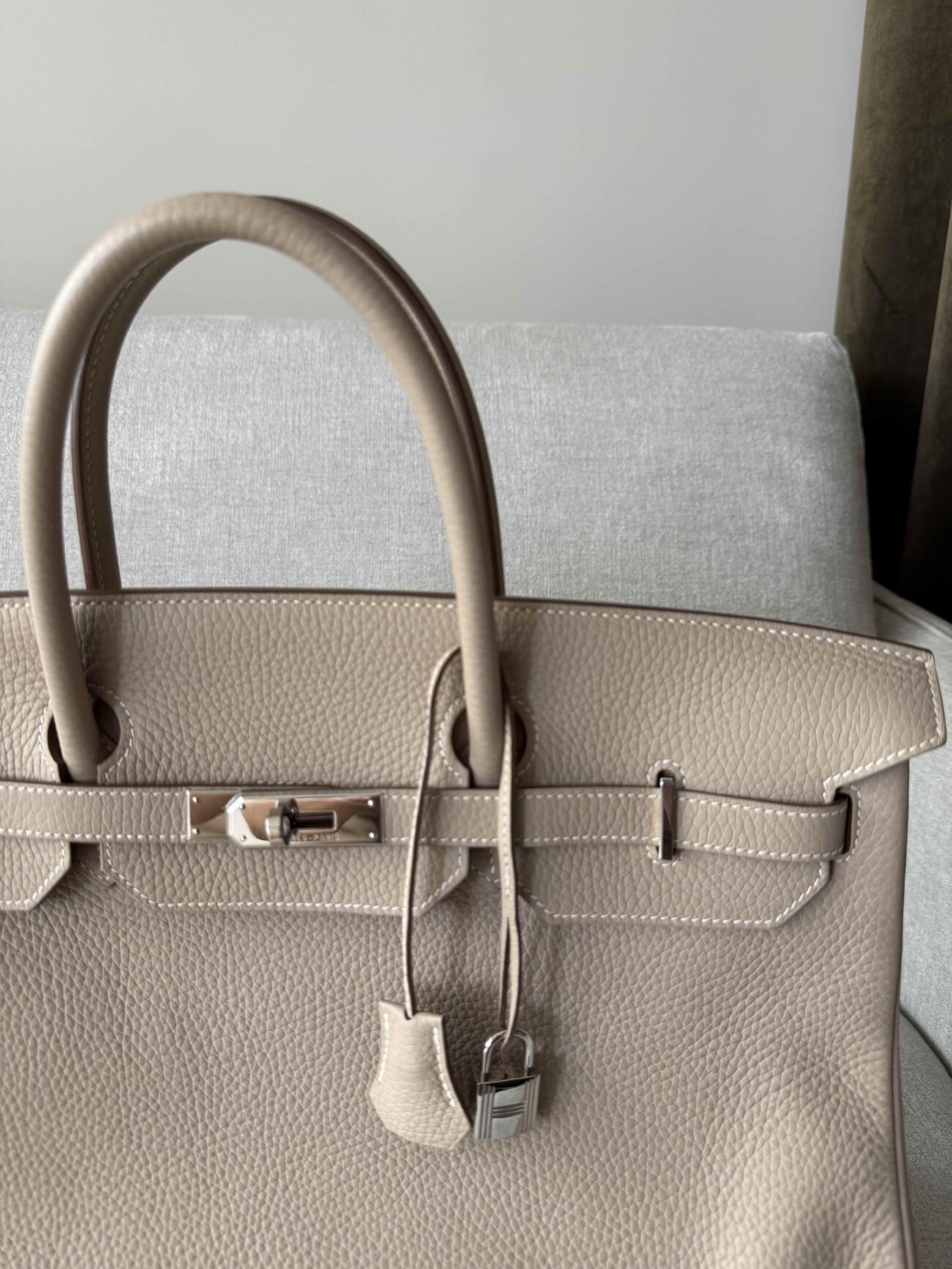 Hermès Birkin 40 Argile in Clémence leather with palladium hardware, close-up front view showing handles, closure and padlock.